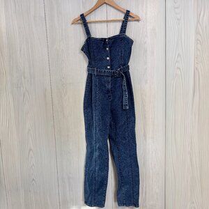 Good American Belted Corset Denim Jumpsuit in a mid-wash blue